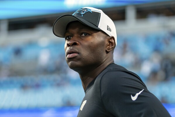 FILE - Carolina Panthers defensive coordinator Ejiro Evero looks on before an NFL football game against the New Orleans Saints Monday, Sept. 18, 2023, in Charlotte, N.C. Evero met again with the Atlanta Falcons to discuss their head coaching vacancy, Wednesday, Jan. 24, 2024, joining Rams assistant Raheem Morris and former Patriots coach Bill Belichick in receiving second interviews.(AP Photo/Jacob Kupferman, File)