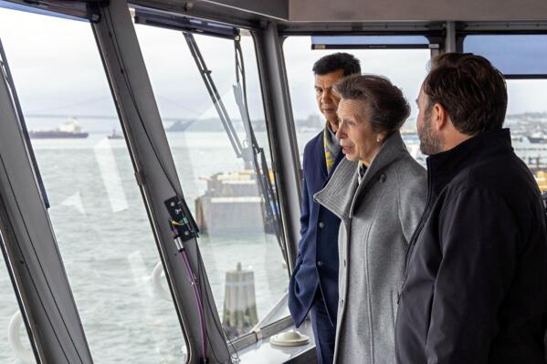 This photo, provided by the New York City Department of Transportation shows Britain's Princess Anne, accompanied by the agency's Commissioner Ydanis Rodriguez, left, as she rides in the pilothouse of the Staten Island Ferry "Sandy Ground," in New York Harbor, Tuesday, Oct. 4, 2022. The trip on a the commuter ferry came after the princess was given a tour of Staten Island's National Lighthouse Museum that included an an unveiling of a miniature figurine of Needles Lighthouse, in the Isle of Wight, in memory of her parents. (Sigurjon Gudjonsson/New York City Department of Transportation via AP)