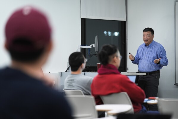 Dr. Pei Wang teaches a artificial general intelligence class at Temple University in Philadelphia, Thursday, Feb. 1, 2024. Mainstream AI research "turned away from the original vision of artificial intelligence, which at the beginning was pretty ambitious,” said Wang. (AP Photo/Matt Rourke)