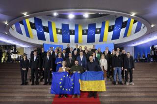 FILE - In this photo provided by the Ukrainian Presidential Press Office, Ukrainian President Volodymyr Zelenskyy, center, European Commission President Ursula von der Leyen, left, Ukrainian Prime Minister Denys Shmyhal, EU and Ukraine official pose for a photo during the EU-Ukraine summit in Kyiv, Ukraine, Thursday, Feb. 2, 2023. War has been a catastrophe for Ukraine and a crisis for the globe. One year on, thousands of civilians are dead, and countless buildings have been destroyed. Hundreds of thousands of troops have been killed or wounded on each side. (Ukrainian Presidential Press Office via AP, File)