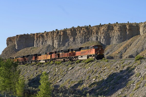  FILE - A train transports freight on a common carrier line near Price, Utah, July 13, two thousand and twenty-three The Supreme Court has agreed to consider reviving a critical approval for a railroad project that would carry crude oil and boost fossil fuel production in rural eastern Utah. The justices said Monday they will review an appeals court ruling that overturned the approval issued by the Surface Transportation Board for the Uinta Basin Railway,  an 88-mile railroad line. (AP Photo/Rick Bowmer, File)