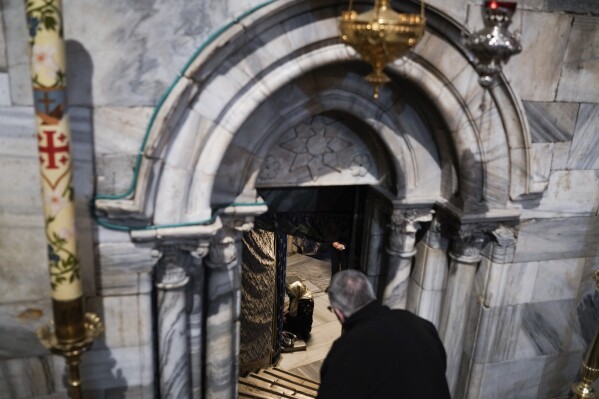 People visit the Grotto under the Church of the Nativity, traditionally believed to be the birthplace of Jesus, on Christmas Eve, in the West Bank city of Bethlehem, Sunday, Dec. 24, 2023. Bethlehem is having a subdued Christmas after officials in Jesus' traditional birthplace decided to forgo celebrations due to the Israel-Hamas war. (AP Photo/Leo Correa)