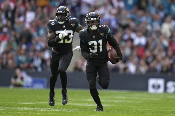 Jacksonville Jaguars cornerback Darious Williams (31) runs with the ball to score a touchdown during an NFL football game between the Atlanta Falcons and the Jacksonville Jaguars at Wembley stadium in London, Sunday, Oct. 1, 2023. (AP Photo/Kirsty Wigglesworth)