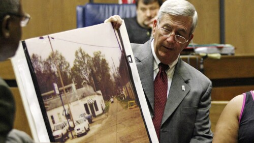 FILE - Prosecutor Doug Evans holds a photo during a trial for Curtis Flowers on June 14, 2010, in Greenwood, Miss. Evans is resigning Friday, June 30, 2023, after more than 30 years as district attorney and four years after the U.S. Supreme Court overturned Flowers' final conviction because it found that Evans had excluded Black people from jury service. Evans tried Flowers six times in the 1996 killings of four people. Flowers, who was released from prison in 2019, always maintained his own innocence. (Taylor Kuykendall/The Commonwealth via AP, File)