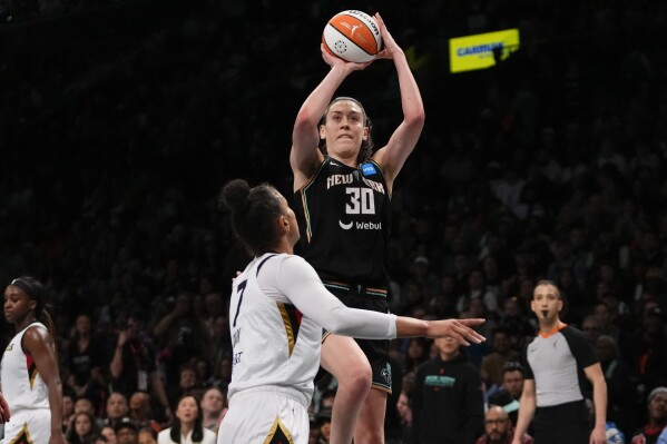 FILE - New York Liberty's Breanna Stewart (30) shoots over Las Vegas Aces' Kelsey Plum (7) during the second half in Game 3 of a WNBA basketball final playoff series Oct. 15, 2023, in New York. Reigning WNBA MVP Stewart re-signed with the Liberty, the team announced Monday, Feb. 26, 2024. (AP Photo/Frank Franklin II, File)