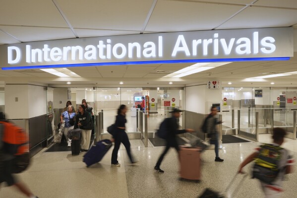 Passengers arrive on international flights at Miami International Airport, Monday, June 9, 2025, in Miami. (AP Photo/Rebecca Blackwell)
