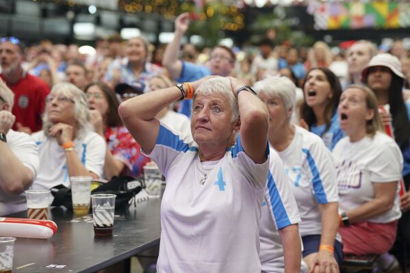 England fans react as they watch a screening of the FIFA Women's World Cup 2023 final between England and Spain at BOXPARK Wembley in London, Sunday Aug. 20, 2023. (Lucy North/PA via AP)
