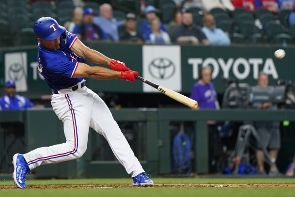 Texas Rangers' Wyatt Langford flies out during the seventh inning of a spring training baseball game against the Boston Red Sox, Monday, March 25, 2024, in Arlington, Texas. (AP Photo/Sam Hodde)