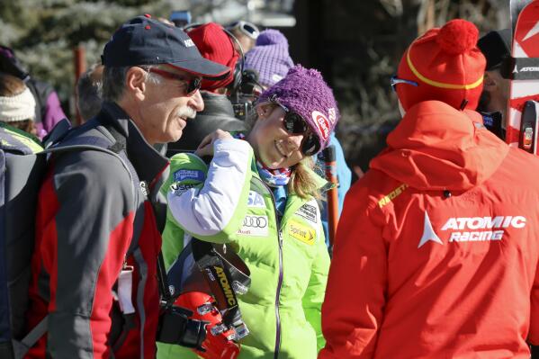 FILE - Mikaela Shiffrin, center, talks with her ski technician, right, along with her father, Jeff Shiffrin, left, after a practice run for the women's World Cup ski race in Aspen, Colo., Nov. 23, 2012. Jeff Shiffrin died at age 65 on Feb. 2, 2020, in an accident at the family home in Colorado, (AP Photo/Nathan Bilow, File)