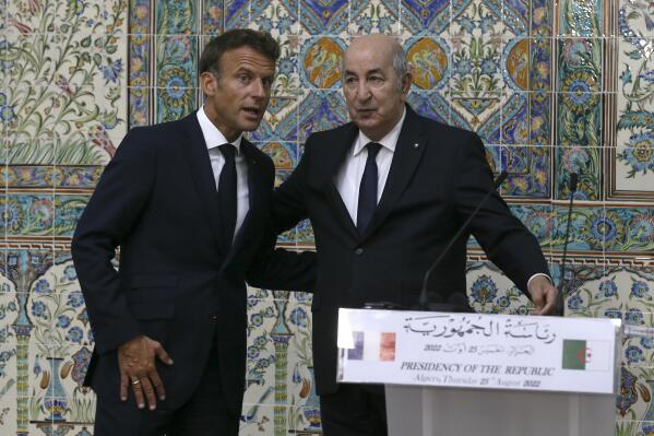 French President Emmanuel Macron, left, reacts with Algerian President Abdelmajid Tebboune during a press conference Thursday, Aug. 25, 2022 in Algiers. Emmanuel Macron arrived in Algeria for a three-day visit aimed at addressing two major challenges: boosting future economic relations and healing colonial-era wounds. The visit comes less than a year after a monthlong diplomatic crisis between the two countries stirred up tensions 60 years after the North African country won its independence from France. (AP Photo/Anis Belghoul)