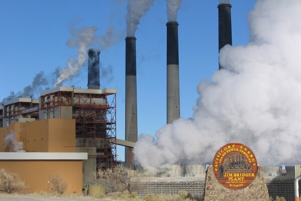 FILE- Steam rises from the huge boiler units at the coal-fired Jim Bridger Power Plant on Nov. 29, 2006, east of Rock Springs, Wyo. A Wyoming coal mine that supplies fuel to the nearby power plant that will be converted to burn gas instead of coal will lay off 19 workers. They're the latest of thousands of jobs lost in recent years in the beleaguered U.S. coal industry. Black Butte Mine Manager Steve Gili said Wednesday, Nov. 29, 2023, no further layoffs are planned after the layoffs in mid-December. (Jeff Gearino/The Casper Star-Tribune via AP, File)