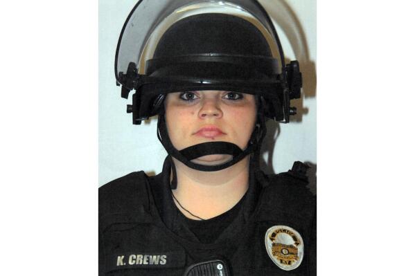 This image provided by the Louisville Metro Police Department shows former Louisville Metro Police officer Katie R. Crews in riot gear following the fatal shooting of a barbecue restaurant owner on June 1, 2020, in Louisville, Ky. Crews pleaded guilty on Tuesday, Oct. 12, 2022, to a federal charge of using excessive force during curfew enforcement the night of McAtee’s death. (Louisville Metro Police Department via AP)