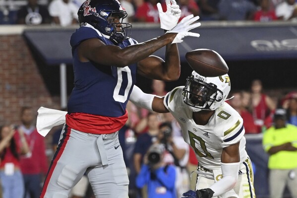 Mississippi tight end Michael Trigg, left, drops a pass under pressure from Georgia Tech defensive back Myles Sims during the first half an NCAA college football game in Oxford, Miss., Saturday, Sept. 16, 2023. (AP Photo/Thomas Graning)