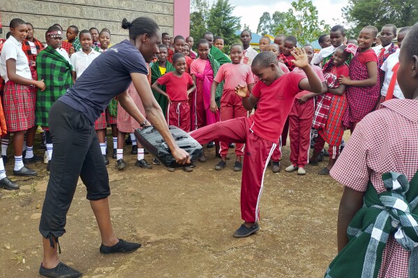I'm Worth Defending officer Amelia Awuor, left, demonstrates self-defense techniques at Enkakenya Centre for Excellence in Narok County, Kenya on Feb. 1, 2025. (AP Photo/Nicholas Komu)