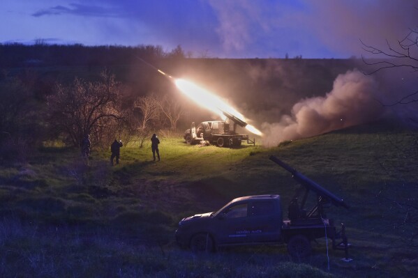 In this photo provided by Ukraine's 65th Mechanised Brigade press service, Ukrainian servicemen fire a multiple launch rocket system based on a pickup truck in the Zaporizhzhia region, Ukraine, Tuesday, April 8, 2025, (Andriy Andriyenko/Ukraine's 65th Mechanised Brigade via AP)
