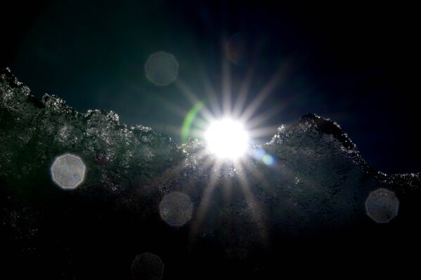 The sun shines behind the Jamtalferner Glacier near Galtuer, Austria, Wednesday, Sept. 6, 2023. (AP Photo/Matthias Schrader)