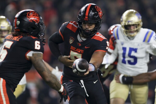 Oregon State quarterback DJ Uiagalelei 5 hands off the ball to running back Damien Martinez 6 during the second half of the teams NCAA college football game against UCLA on Saturday Oct 14 2023 in Corvallis Ore AP PhotoAmanda Loman