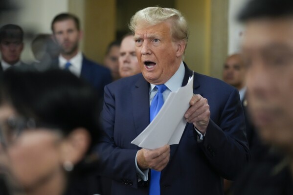 Former President Donald Trump speaks to reporters during a lunch break at New York Supreme Court in New York, Monday, Oct. 2, 2023. (AP Photo/Seth Wenig)