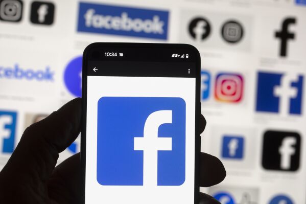 FILE - The Facebook logo is seen on a cell phone in Boston, USA, Oct. 14, 2022. The European Union said Tuesday April 30, 2024 that it's scrutinizing Facebook and Instagram over a range of suspected violations of the bloc's digital rulebook, including not doing enough to protect users from foreign disinformation ahead of EU-wide elections. (Ǻ Photo/Michael Dwyer, File)