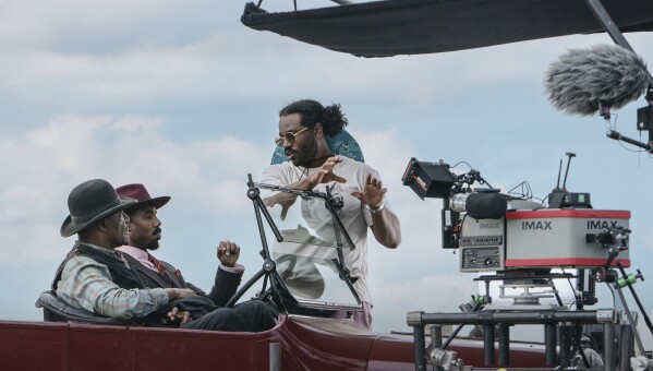 This image released by Warner Bros. Pictures shows actors Delroy Lindo, from left, and Michael B. Jordan with director-writer-producer Ryan Coogler on the set of "Sinners." (Eli Adé/Warner Bros. Pictures via AP)