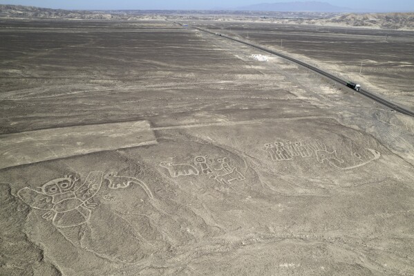 Geoglyphs known as the Nazca Lines are visible next to the Pan American Highway in La Pampa de Nazca, Peru, May 17, 2023. (AP Photo/Martin Mejia, File)