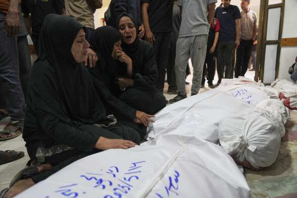 Palestinians mourn their relatives killed in an Israeli airstrikes in Jabalia, northern Gaza Strip, on Wednesday, May 14, 2025. According to local hospitals, 48 people were killed in the strikes, including 22 children. (AP Photo/Jehad Alshrafi)
