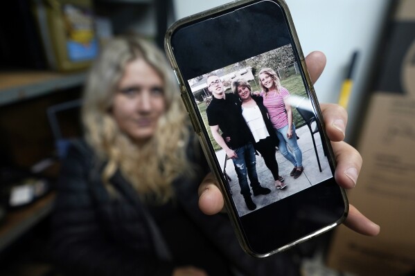 Lisa Hohnstreiter holds a smartphone displaying a photograph of her mother, Nancy Harrison, and her brother, Friday, Nov. 24, 2023, in Warren, Mich. Not long after DeAngelo Martin was released from jail, he killed for the second time. On March 19, 2019, the body of Nancy Harrison, 52, was discovered in an abandoned house on Coventry Street. (AP Photo/Carlos Osorio)