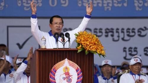 FILE - Cambodia Prime Minister Hun Sen, center, also President of Cambodian People's Party, delivers a speech during his party election campaign in Phnom Penh Cambodia, Saturday, July 1, 2023. Two senior members of Cambodia’s opposition Candlelight Party have been arrested for allegedly teaching voters how to cast a null ballot in this month's general election, becoming the first people to be arrested under the country's recently amended election law. (AP Photo/Heng Sinith, File)