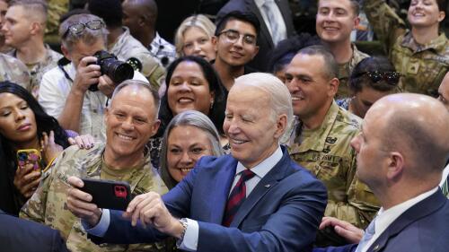 President Joe Biden takes a selfie during a visit to Fort Liberty, NC, Friday, June 9, 2023. (AP Photo/Susan Walsh)