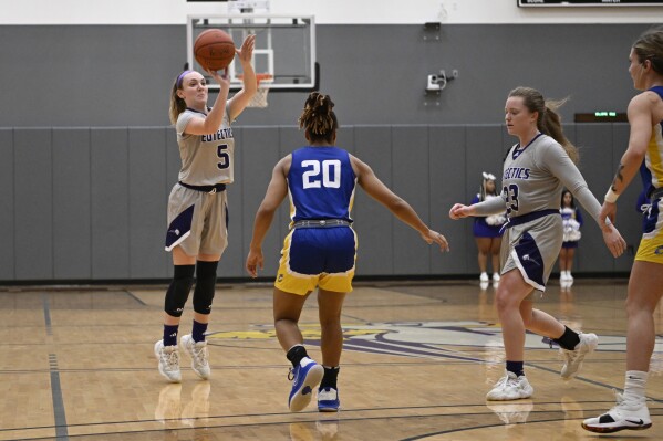 University Health Sciences and Pharmacy guard Grace Beyer (5) shoots during an NAIA college basketball game against Cottey College Thursday, Feb. 22, 2024, in St. Louis. On the same night that Caitlin Clark was adding to her NCAA women's basketball scoring record before a packed house in Indiana, and a national audience on television, the Iowa sensation lost ground to the most prolific scorer in her sport. (AP Photo/Jeff Le)