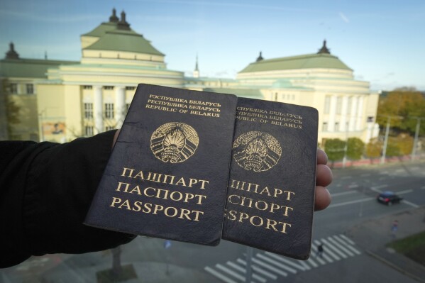 Two Belarusian passports are displayed in Tallinn, Estonia, on Wednesday, Oct. 25, 2023. Belarus has stopped renewing passports at its embassies abroad, and hundreds of thousands of Belarusians who have fled President Alexander Lukashenko's repressive regime cannot update their travel documents without returning home and risking possible arrest. (AP Photo/Sergei Grits)