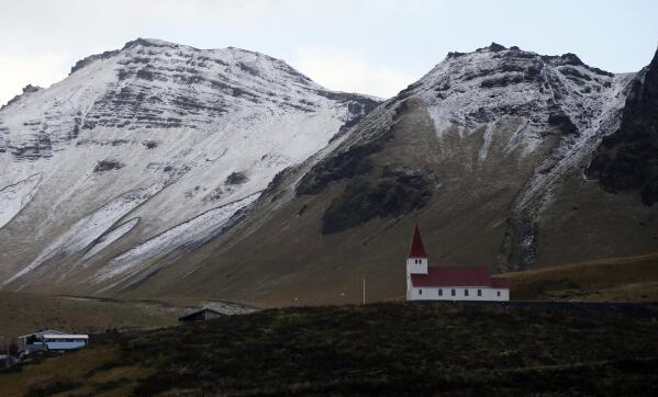 FILE - In this Oct. 26, 2016 file photo, the church of Vik, Iceland, near the Volcano Katla, After a summer of increased seismic activity at Katla, Icelanders are obsessing over the smallest sign of an eruption at the country’s most closely watched volcano. Katla last erupted in 1918. Never before in recorded history, dating back to the 12th century, have 99 years passed without an eruption from the volcano. (AP Photo/Frank Augstein, File)