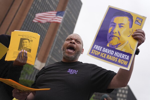 People gather to protest the deployment of the National Guard in Los Angeles and the detainment of union leader David Huerta near Independence Hall in Philadelphia, Monday, June 9, 2025. (AP Photo/Matt Rourke)