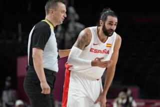 Spain's Ricky Rubio, right, questions a call during a men's basketball preliminary round game against Argentina at the 2020 Summer Olympics, Thursday, July 29, 2021, in Saitama, Japan. (AP Photo/Eric Gay)