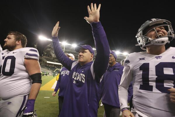 Kansas State head coach Chris Klieman, center, thanks the fans after defeating Baylor in an NCAA college football game, Saturday, Nov. 12, 2022, in Waco, Texas. (AP Photo/Jerry Larson)