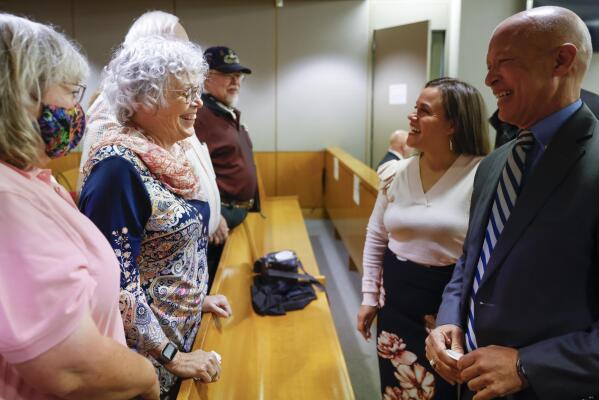 Anne Brooks, second from left, oldest daughter of victim Mary Brooks reacts while speaking to district attorney John Creuzot, right, after Billy Chemirmir was found guilty of killing 87-year-old Mary Brooks by the members of the jury during the final day of his third court trial at Frank Crowley Courts Building in Dallas on Friday, Oct. 7, 2022. Chemirmir, 49, is charged with capital murder of 22 elderly people in North Texas. Jurors deliberated less than 30 minutes. (Shafkat Anowar/The Dallas Morning News via AP)