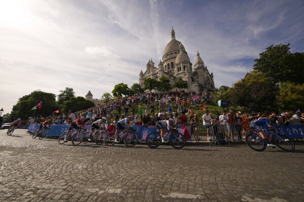 Competitors ride past the Sacre Coeur basilica, during the women's road cycling event, at the 2024 Summer Olympics, Sunday, Aug. 4, 2024, in Paris, France. (AP Photo/Vadim Ghirda, File)