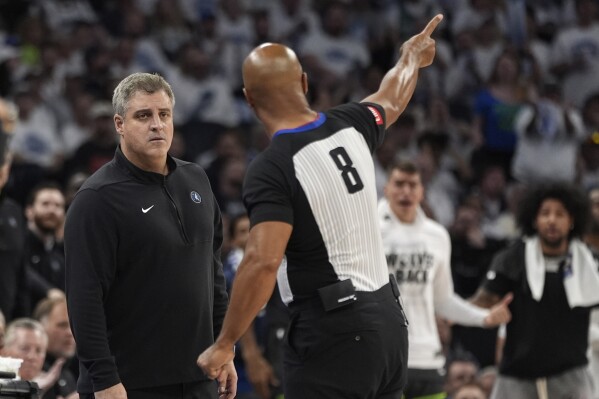 Minnesota Timberwolves assistant coach Micah Nori, left, listens to referee Marc Davis (8) explain a call during the second half of Game 5 of the Western Conference finals in the NBA basketball playoffs against the Dallas Mavericks, Thursday, May 30, 2024, in Minneapolis. (AP Photo/Abbie Parr)