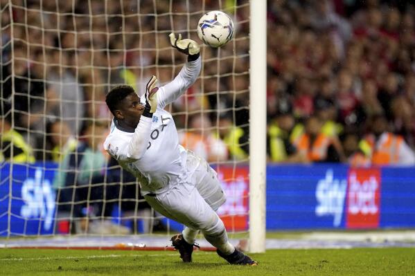 Nottingham Forest goalkeeper Brice Samba saves a penalty kick by Sheffield United's Oliver Norwood during a shootout in a Sky Bet Championship play-off semi-final, second leg soccer match at the City Ground, Nottingham, England, Tuesday May 17, 2022. (Zac Goodwin/PA via AP)