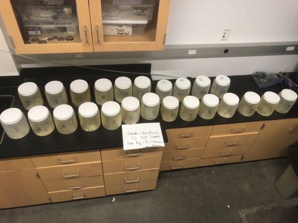 This July 22, 2024, image provided by Michael Ketterer shows jars of water samples from Acid Canyon in Los Alamos, N.M. (Michael Ketterer via AP)