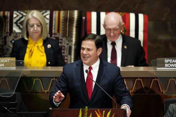 Republican Gov. Doug Ducey, front, gives his state of the state address at the Arizona Capitol as Arizona House Speaker Rusty Bowers, right, R-Mesa, Arizona Senate President Karen Fann, R-Prescott, sit behind him Monday, Jan. 10, 2022, in Phoenix. (AP Photo/Ross D. Franklin)