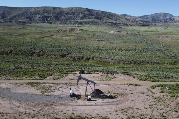 A pumpjack dips its head to extract oil in a basin north of Helper, Utah, July 13, 2023. (AP Photo/Rick Bowmer, File)