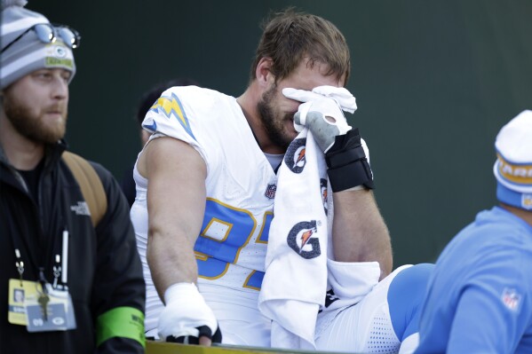 Los Angeles Chargers linebacker Joey Bosa is crated off the field during the first half of an NFL football game against the Green Bay Packers, Sunday, Nov. 19, 2023, in Green Bay, Wis. (AP Photo/Matt Ludtke)