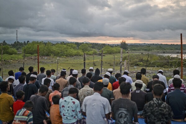 Ethnic Rohingya men offer evening prayers at their camp in Pidi, Aceh province, Indonesia, on Friday, Dec. 15, 2023.  (AP Photo/Reza Saifullah)