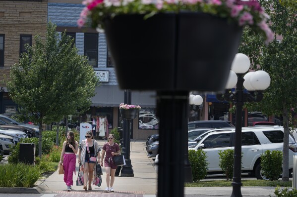 People walk through the town square Wednesday, July 26, 2023 in Lebanon, Tenn. City officials conducted a do-it-yourself census after concern about being under counted by the U.S. Census Bureau in 2020. (AP Photo/George Walker IV)