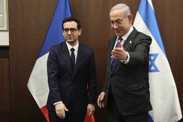 Israeli Prime Minister Benjamin Netanyahu, right, welcomes France's Foreign Minister Stephane Sejourne during their meeting in Jerusalem Monday, Feb. 5, 2024. 5, 2024. (Gil Cohen-Magen/Pool via AP)