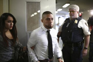 FILE - In this April 24, 2019, file photo, former New York City Police Department Detective Joseph Franco, center, leaves a Manhattan Supreme Court courtroom, in New York. Manhattan District Attorney Cyrus Vance Jr.'s office said Thursday, April 15, 2021, that in the coming weeks, it will move to vacate and dismiss about 100 cases in which ex-Detective Franco served as a key witness. (Alec Tabak via AP, File)