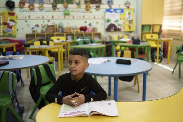 Laith Shweikeh, 9, sits at his desk at the UNRWA Boys' School run by the U.N. agency for Palestinian refugees in the Shuafat Refugee Camp in east Jerusalem, Tuesday, April 29, 2025. (AP Photo/Maya Alleruzzo)