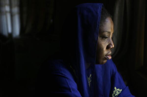 Amina Ahmed, the wife of Muhammad Mubarak Bala, an atheist who has been detained since April 2020, is photograph in her home in Abuja, Nigeria, Sunday, Nov. 21, 2021. Bala was held incommunicado in police custody for so long — eight months — that Ahmed was sure he was dead. “I couldn’t eat. I couldn’t sleep. The emotional torture was too much for me,” she says. (AP Photo/Sunday Alamba)