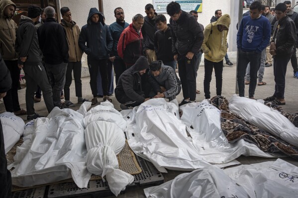 Palestinians mourn their relatives killed in the Israeli bombardment of the Gaza Strip, at the hospital Rafah, southern Gaza, Thursday, Dec. 21, 2023. (AP Photo/Fatima Shbair)